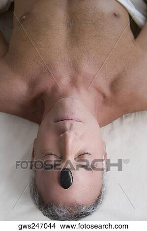 High angle view of a senior man lying on a massage table View Large Photo Image Picture - High angle view of a senior man lying on a massage table. Fotosearch