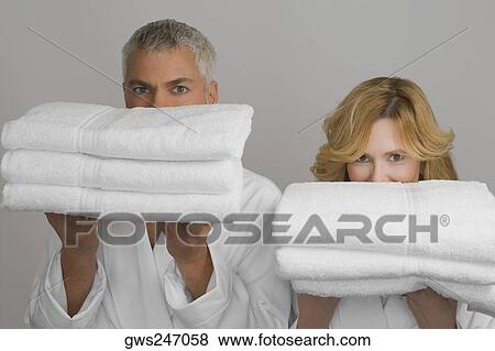 Portrait of a mature couple holding folded towels View Large Photo Image Stock Photo - Portrait of a mature couple holding folded towels. Fotosearch
