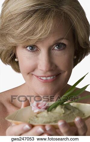 Portrait of a mature woman holding a bowl of herb View Large Photo Image Stock Image - Portrait of a mature woman holding a bowl of herb. Fotosearch