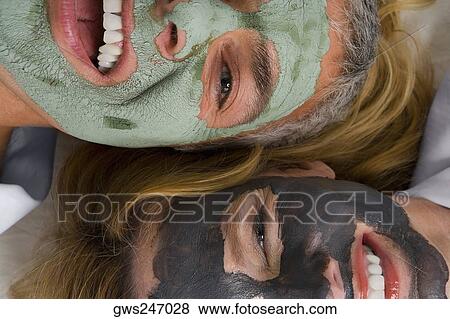 Portrait of a mature woman with her daughter wearing facial masks and smiling View Large Photo Image Stock Photo - Portrait of a mature woman with her daughter wearing facial masks and smiling. Fotosearch