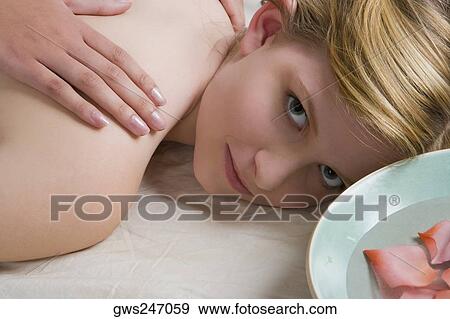 Portrait of a teenage girl getting a back massage View Large Photo Image Stock Photo - Portrait of a teenage girl getting a back massage. Fotosearch
