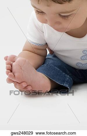 Close-up of a baby boy touching his sole of foot View Large Photo Image Stock Photo - Close-up of a baby boy touching his sole of foot. Fotosearch