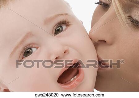 Close-up of a mid adult woman kissing her son View Large Photo Image Stock Image - Close-up of a mid adult woman kissing her son. Fotosearch
