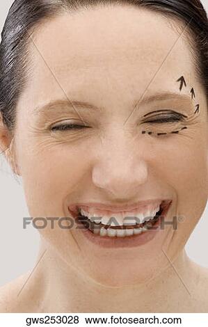 Close-up of a young woman with pre-surgical markings on her face and smiling View Large Photo Image Stock Photo - Close-up of a young woman with pre-surgical markings on her face and smiling. Fotosearch