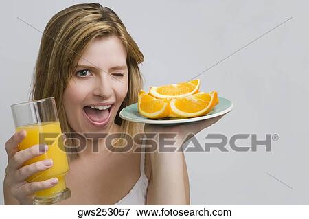 Portrait of a teenage girl holding a plate of oranges and a glass of orange juice View Large Photo Image Stock Photo - Portrait of a teenage girl holding a plate of oranges and a glass of orange juice. Fotosearch