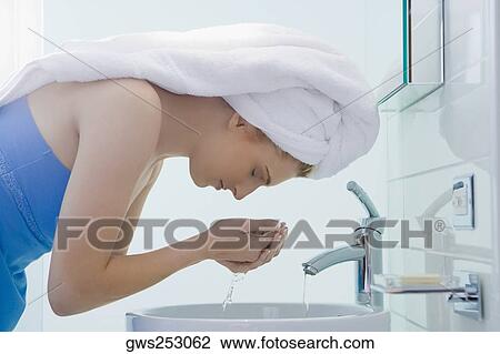 Side profile of a young woman washing her face View Large Photo Image Stock Image - Side profile of a young woman washing her face. Fotosearch
