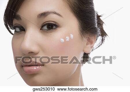Three dots of moisturizing cream on a woman's face View Large Photo Image Stock Image - Three dots of moisturizing cream on a woman's face. Fotosearch