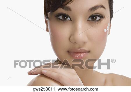 Three dots of moisturizing cream on a woman's face View Large Photo Image Stock Image - Three dots of moisturizing cream on a woman's face. Fotosearch