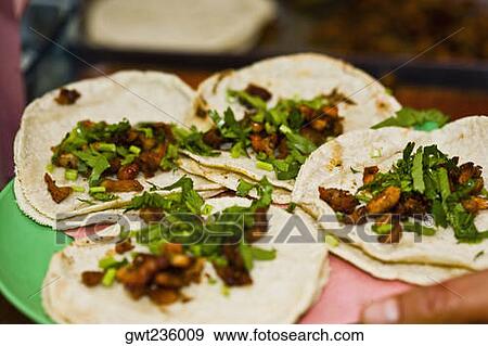 Stock Photo - Close-up of four Mexican tacos on a plate, Cuetzalan, Puebla State, Mexico. Fotosearch