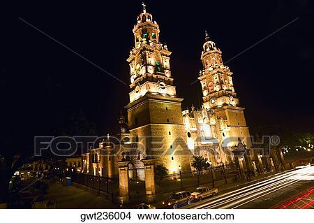 Picture - Low angle view of a cathedral lit up at night, Morelia Cathedral, Morelia, Michoacan State, Mexico. Fotosearch