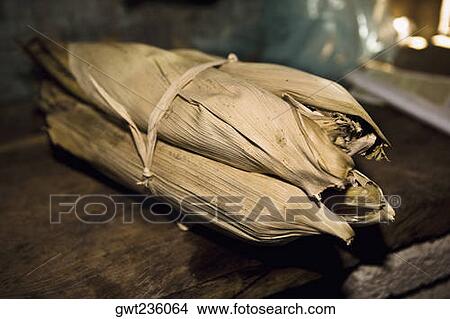 Picture - Mexican steamed tamales wrapped in dried corn husks. Fotosearch