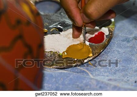 Close-up of a person's hand holding a paintbrush, Arrazola, Oaxaca State, Mexico View Large Photo Image Stock Image - Close-up of a person's hand holding a paintbrush, Arrazola, Oaxaca State, Mexico. Fotosearch