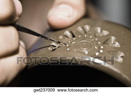 Stock Photo - Close-up of a person's hand making pottery, San Bartolo Coyotepec, Oaxaca State, Mexico. Fotosearch