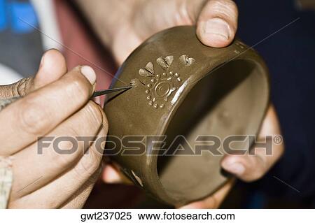 Stock Photography - Close-up of a person's hand making pottery, San Bartolo Coyotepec, Oaxaca State, Mexico. Fotosearch