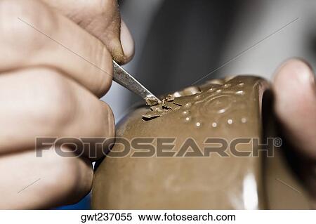 Stock Photography - Close-up of a person's hand making pottery, San Bartolo Coyotepec, Oaxaca State, Mexico. Fotosearch