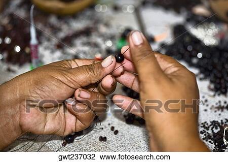 Close-up of a person's hands making beaded jewelry, Izamal, Yucatan, Mexico View Large Photo Image Stock Image - Close-up of a person's hands making beaded jewelry, Izamal, Yucatan, Mexico. Fotosearch