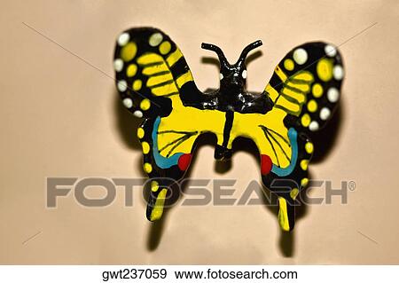 Stock Photo - Close-up of an artificial butterfly on the wall, Izamal, Yucatan, Mexico. Fotosearch