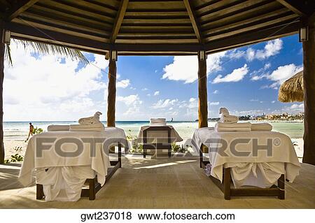 Towels on tables under a palapa, Playa Del Carmen, Quintana Roo, Mexico View Large Photo Image Stock Photo - Towels on tables under a palapa, Playa Del Carmen, Quintana Roo, Mexico. Fotosearch