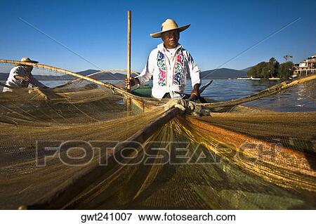 Fisherman with butterfly fishing net in a lake, Janitzio Island, Lake Patzcuaro, Patzcuaro, Michoacan State, Mexico View Large Photo Image Stock Photo - Fisherman with butterfly fishing net in a lake, Janitzio Island, Lake Patzcuaro, Patzcuaro, Michoacan State, Mexico. Fotosearch