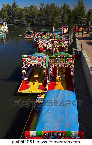 Stock Image - High angle view of trajineras boats in a canal, Xochimilco Gardens, Mexico City, Mexico. Fotosearch