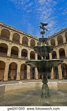 Stock Image - Low angle view of a fountain in the courtyard of a government building, National Palace, Zocalo, Mexico City, Mexico. Fotosearch
