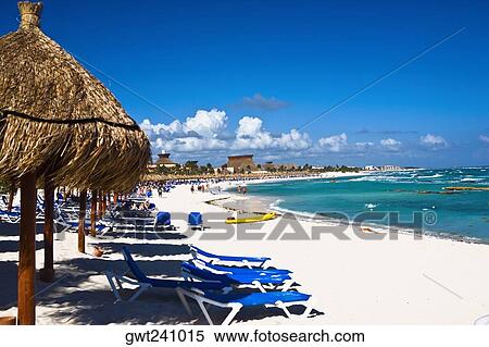 Stock Photography - Palapas and lounge chairs on the beach, Tulum, Quintan Roo, Mexico. Fotosearch