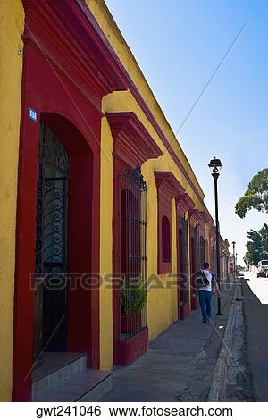 Rear view of a man walking on the sidewalk, Oaxaca, Oaxaca State, Mexico View Large Photo Image Stock Photograph - Rear view of a man walking on the sidewalk, Oaxaca, Oaxaca State, Mexico. Fotosearch