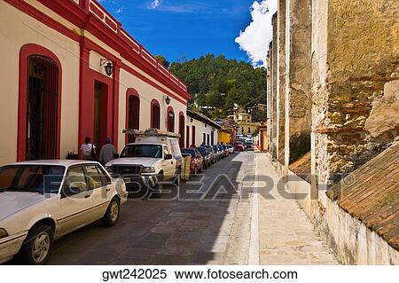 Stock Photography - Cars parked in front of buildings, San Cristobal De Las Casas, Chiapas, Mexico. Fotosearch