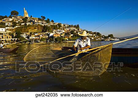 Fisherman with butterfly fishing net in a lake, Janitzio Island, Lake Patzcuaro, Patzcuaro, Michoacan State, Mexico View Large Photo Image Stock Photography - Fisherman with butterfly fishing net in a lake, Janitzio Island, Lake Patzcuaro, Patzcuaro, Michoacan State, Mexico. Fotosearch