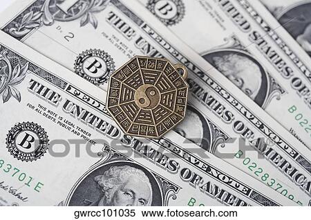 Close-up of a Chinese coin over US paper currency View Large Photo Image Stock Photography - Close-up of a Chinese coin over US paper currency. Fotosearch