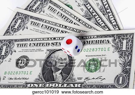 Stock Photo - Close-up of a dice on US paper currency. Fotosearch