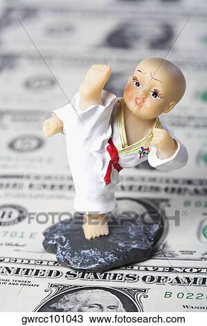 Close-up of a figurine over US paper currency View Large Photo Image Stock Image - Close-up of a figurine over US paper currency. Fotosearch