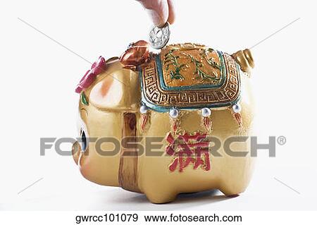 Close-up of a person's hand putting coin into a piggy bank View Large Photo Image Stock Photo - Close-up of a person's hand putting coin into a piggy bank. Fotosearch