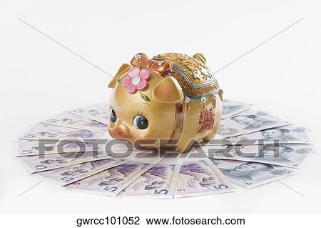 Close-up of a piggy bank on Chinese currency View Large Photo Image Stock Image - Close-up of a piggy bank on Chinese currency. Fotosearch