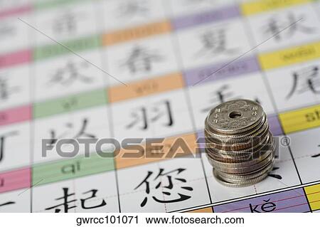 Close-up of coins over Chinese calendar View Large Photo Image Stock Image - Close-up of coins over Chinese calendar. Fotosearch