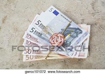 Stock Image - Close-up of European union currency tied with a ribbon. Fotosearch