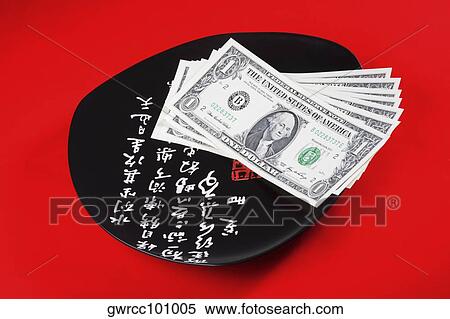 Stock Photography - Close-up of US paper currency in a plate. Fotosearch