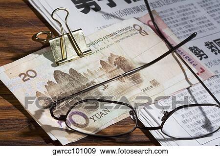 Eyeglasses and Chinese Yuan note on a newspaper View Large Photo Image Stock Photo - Eyeglasses and Chinese Yuan note on a newspaper. Fotosearch