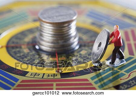 Figurine of manual worker working on a feng shui compass View Large Photo Image Stock Image - Figurine of manual worker working on a feng shui compass. Fotosearch
