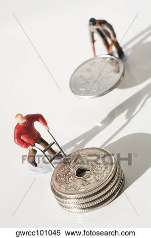 Figurine of manual workers pushing Chinese coins on push cart View Large Photo Image Stock Photography - Figurine of manual workers pushing Chinese coins on push cart. Fotosearch