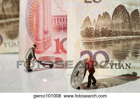 Figurines of manual workers pushing Chinese coins on push carts View Large Photo Image Stock Photo - Figurines of manual workers pushing Chinese coins on push carts. Fotosearch