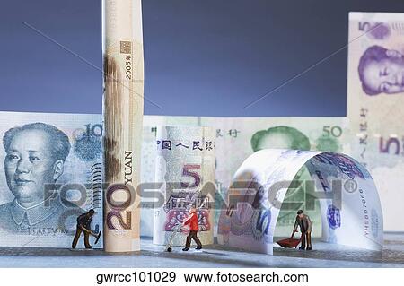Figurines of manual workers with Chinese currency View Large Photo Image Stock Photo - Figurines of manual workers with Chinese currency. Fotosearch