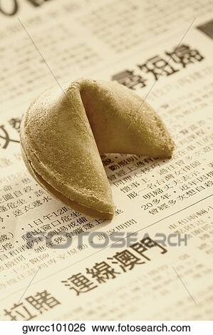 Stock Photograph - Fortune cookie on a newspaper. Fotosearch