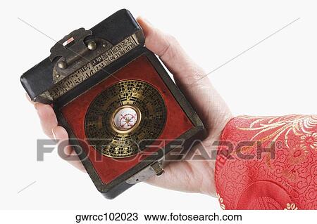 Close-up of a person's hand holding a feng shui compass View Large Photo Image Stock Image - Close-up of a person's hand holding a feng shui compass. Fotosearch