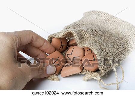 Close-up of a person's hand picking a Viking future divination stone View Large Photo Image Picture - Close-up of a person's hand picking a Viking future divination stone. Fotosearch