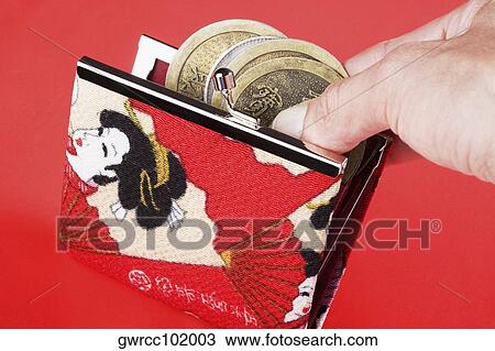 Close-up of a person's hand putting coins in a purse View Large Photo Image Stock Image - Close-up of a person's hand putting coins in a purse. Fotosearch