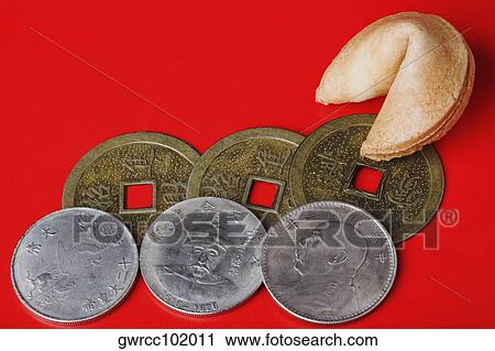 Close-up of Chinese coins with a fortune cookie View Large Photo Image Stock Image - Close-up of Chinese coins with a fortune cookie. Fotosearch