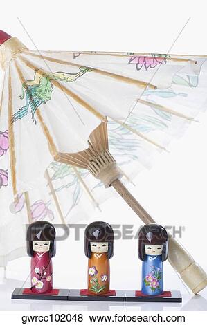 Close-up of Chinese dolls covered with a parasol View Large Photo Image Stock Photo - Close-up of Chinese dolls covered with a parasol. Fotosearch