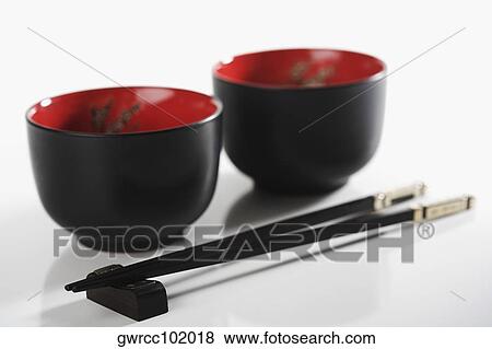 Close-up of chopsticks with two bowls View Large Photo Image Stock Photo - Close-up of chopsticks with two bowls. Fotosearch