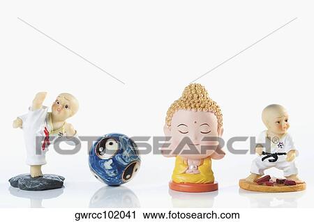 Close-up of figurines with a yin yang ball View Large Photo Image Stock Image - Close-up of figurines with a yin yang ball. Fotosearch